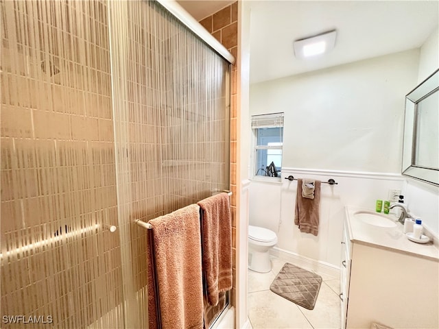 bathroom with vanity, toilet, an enclosed shower, and tile patterned floors