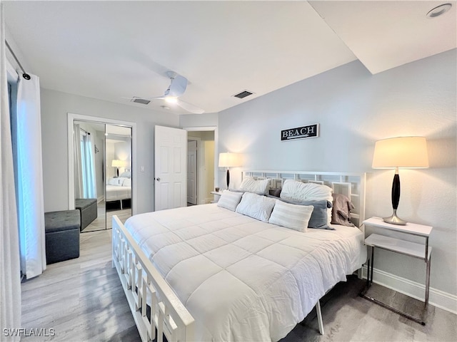 bedroom featuring light wood-type flooring, a closet, and ceiling fan