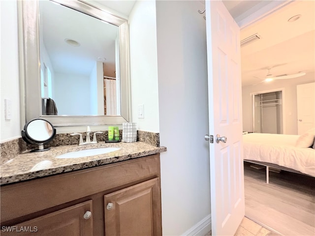 bathroom featuring vanity, hardwood / wood-style floors, and ceiling fan