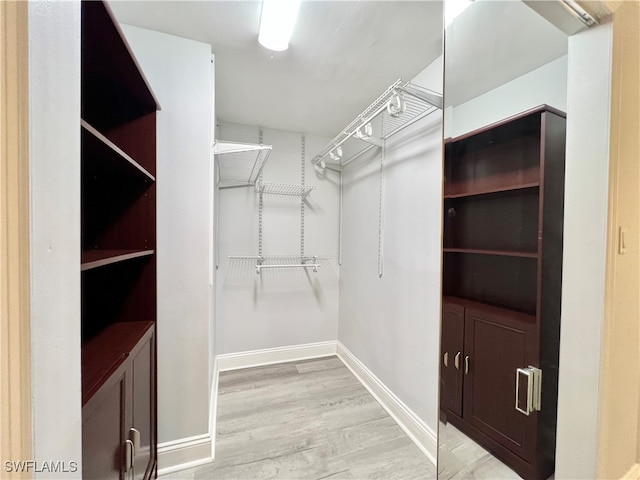 walk in closet featuring light hardwood / wood-style flooring