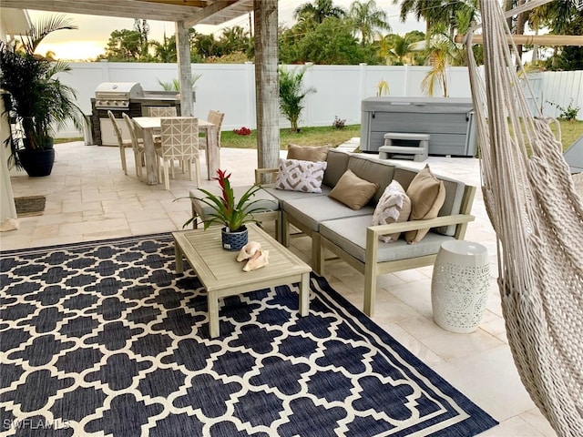 patio terrace at dusk featuring an outdoor living space, a grill, and a hot tub