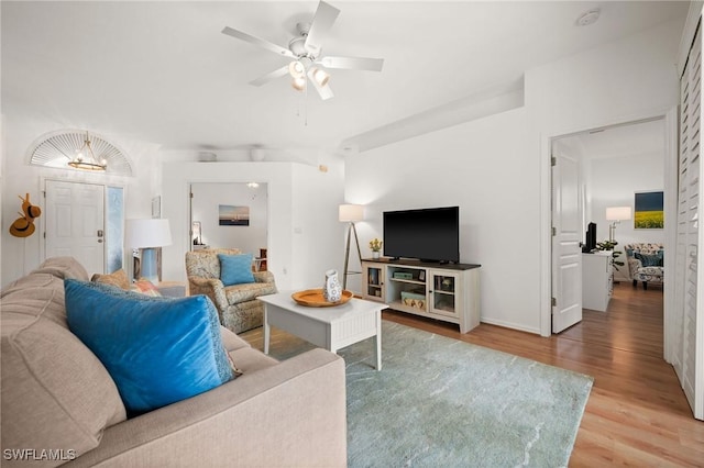 living room featuring ceiling fan and wood finished floors