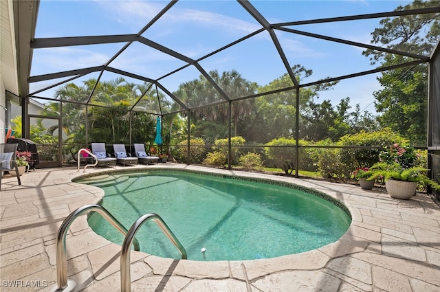 view of swimming pool with glass enclosure and a patio