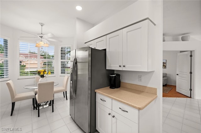 kitchen featuring white cabinets, ceiling fan, stainless steel fridge with ice dispenser, and light tile patterned floors