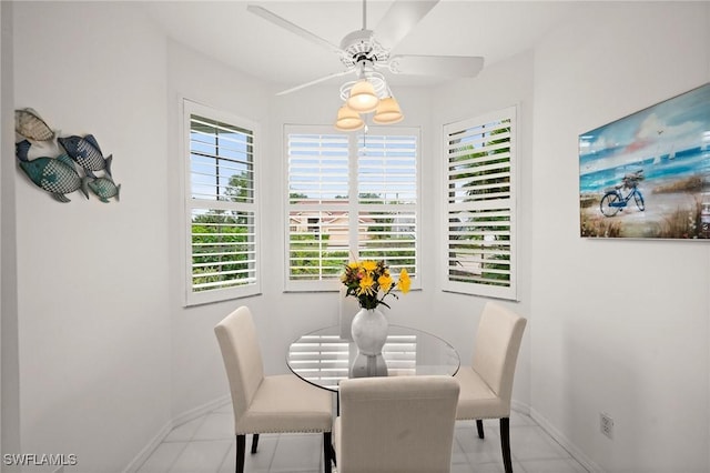 dining area with ceiling fan and baseboards