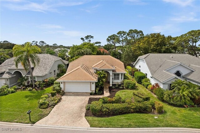 view of front of property with a garage and a front yard