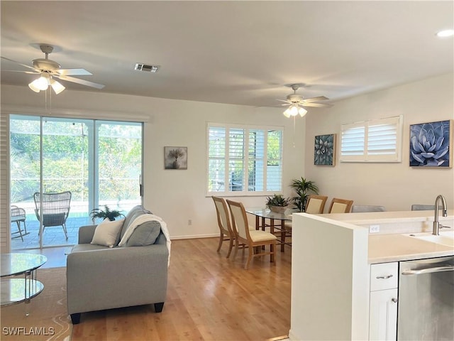 25040 Bay Cedar Dr, Bonita Springs, FL 34134 - living area with light wood-style floors, ceiling fan, baseboards, and visible vents