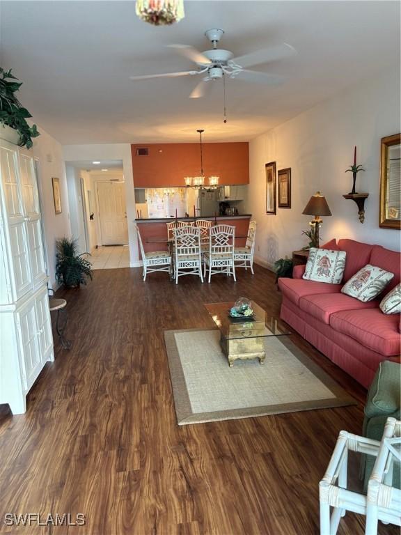 living room with hardwood / wood-style flooring and ceiling fan