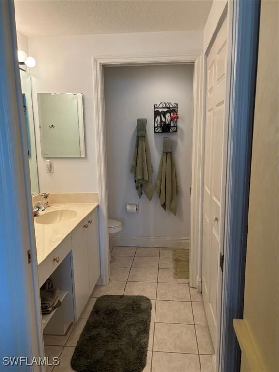 bathroom with tile patterned floors, toilet, and vanity