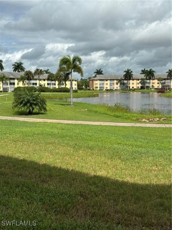 view of community featuring a water view and a lawn