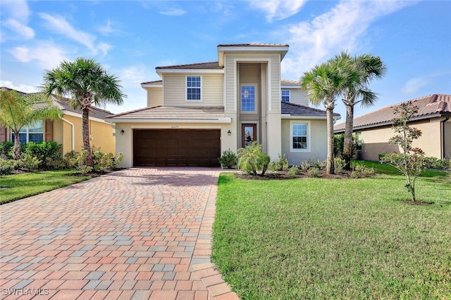 view of front of home featuring a garage and a front lawn