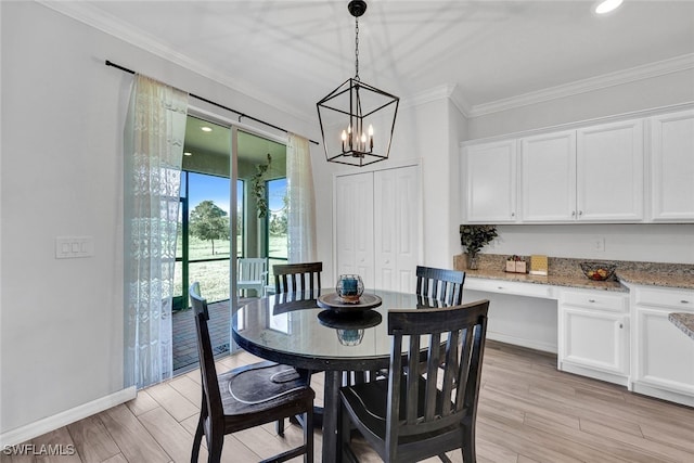 dining area with ornamental molding, a notable chandelier, and light hardwood / wood-style flooring