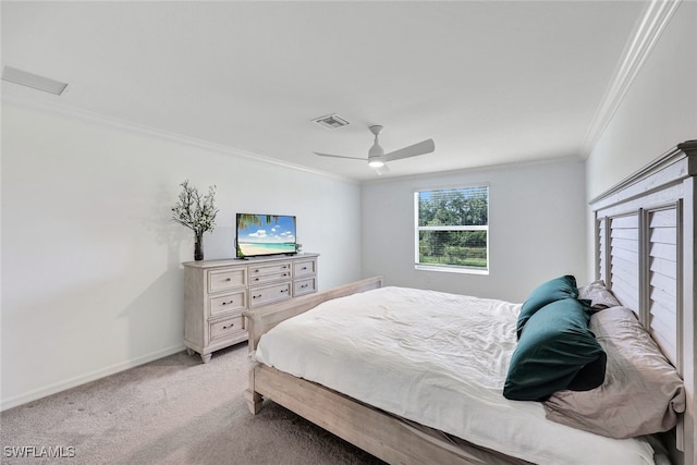 carpeted bedroom with ceiling fan and ornamental molding