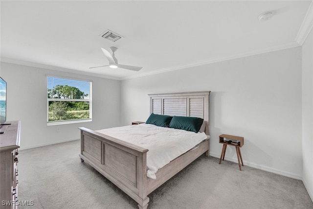 bedroom featuring crown molding, light colored carpet, and ceiling fan