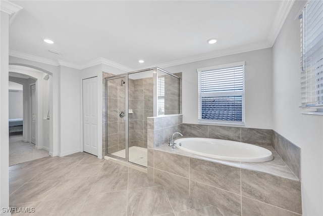 bathroom featuring ornamental molding and independent shower and bath