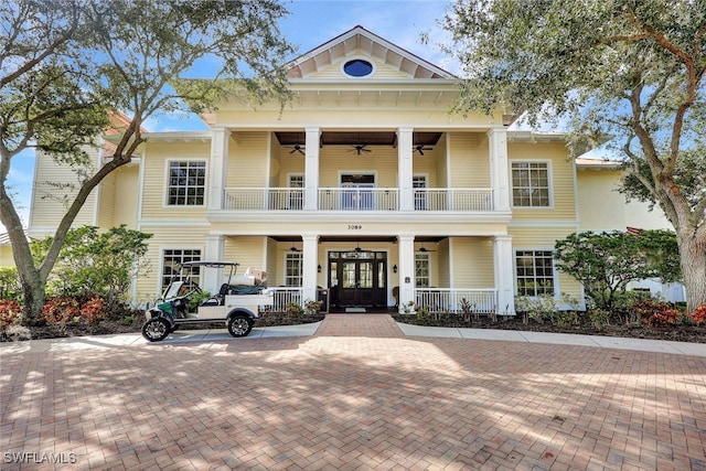 neoclassical / greek revival house featuring a balcony and a porch