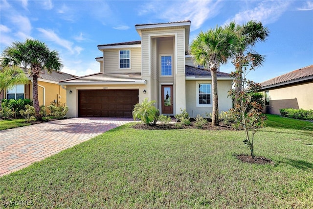 view of front of home with a garage and a front lawn