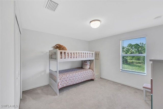 bedroom featuring light carpet