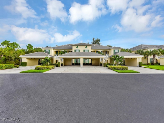 view of front of property with a tiled roof and stucco siding