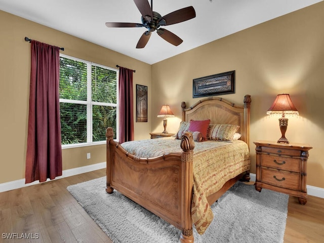 bedroom featuring lofted ceiling, ceiling fan, and light hardwood / wood-style flooring