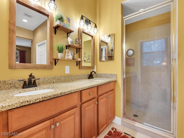 bathroom with vanity, walk in shower, and tile patterned flooring