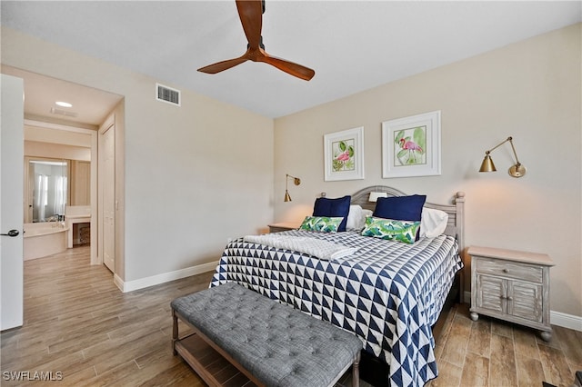 bedroom with ceiling fan, light wood-type flooring, and ensuite bathroom