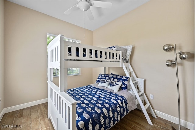 bedroom featuring wood tiled floor, multiple windows, baseboards, and ceiling fan