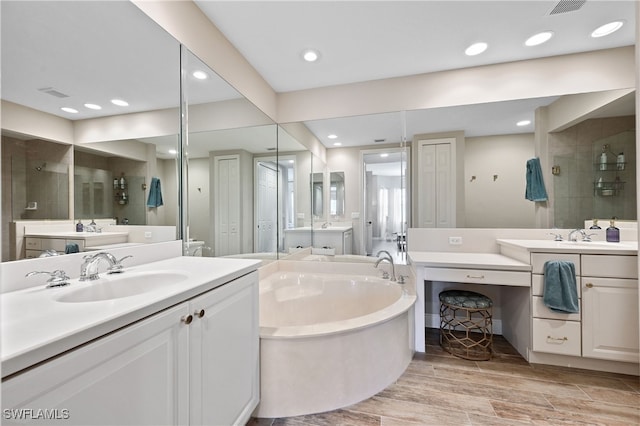 full bathroom with recessed lighting, wood tiled floor, a sink, tiled shower, and a bath