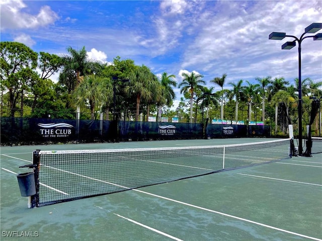 view of tennis court featuring fence