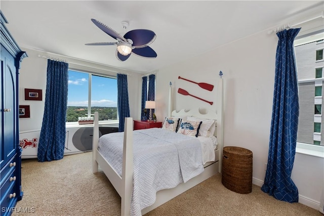 bedroom with light carpet and ceiling fan