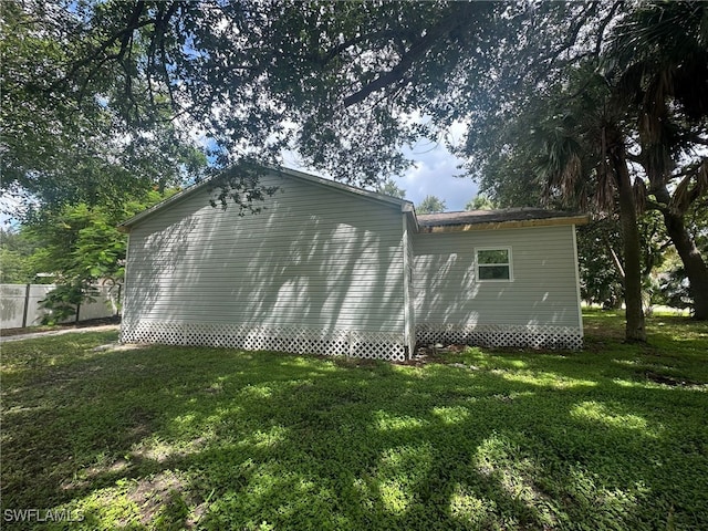 view of side of home featuring a yard