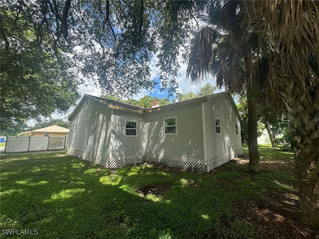 rear view of house with a yard