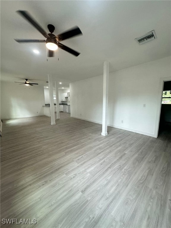 unfurnished living room with light hardwood / wood-style floors and ceiling fan