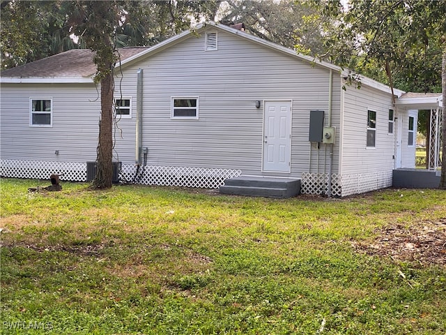 back of house with a lawn