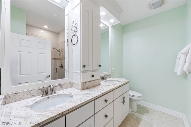 bathroom featuring vanity, toilet, and a shower with shower door