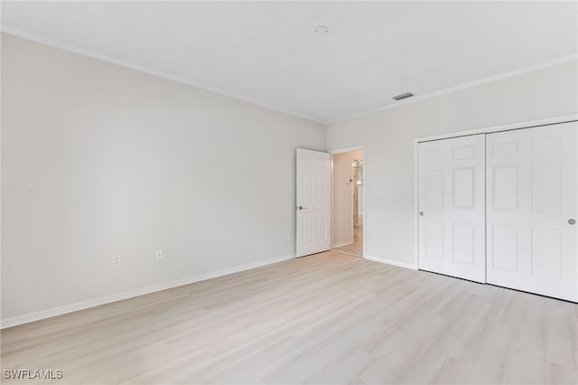 unfurnished bedroom with a closet and light wood-type flooring