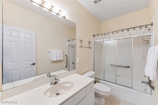 full bathroom featuring combined bath / shower with glass door, a textured ceiling, vanity, tile patterned flooring, and toilet