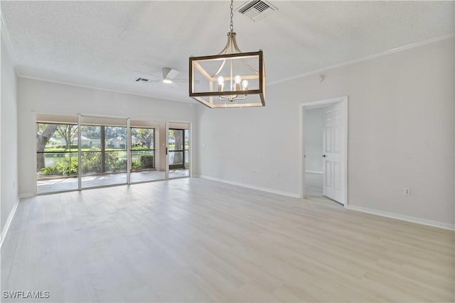 unfurnished room featuring a textured ceiling, light hardwood / wood-style floors, and ornamental molding