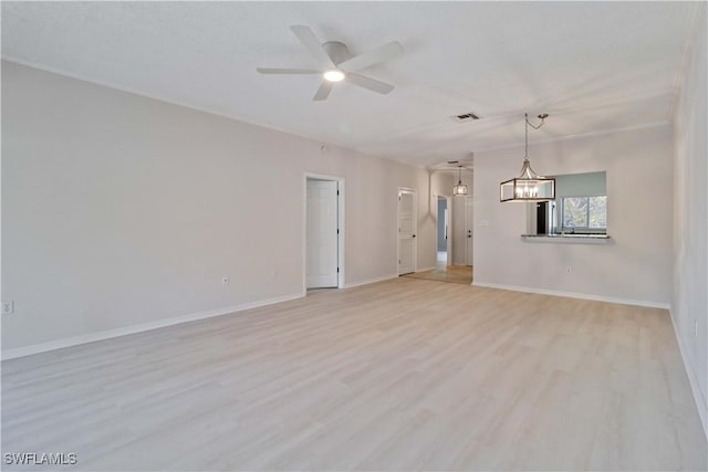 unfurnished living room featuring ceiling fan with notable chandelier and light hardwood / wood-style floors