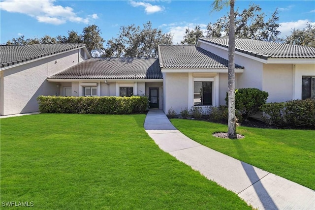 mediterranean / spanish-style home with a front lawn