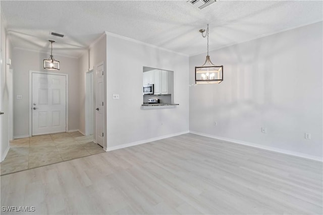 interior space with crown molding, a textured ceiling, and light wood-type flooring