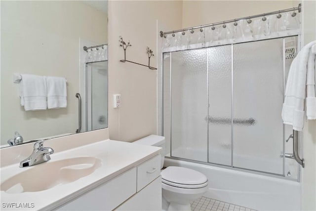 full bathroom featuring tile patterned flooring, vanity, toilet, and combined bath / shower with glass door