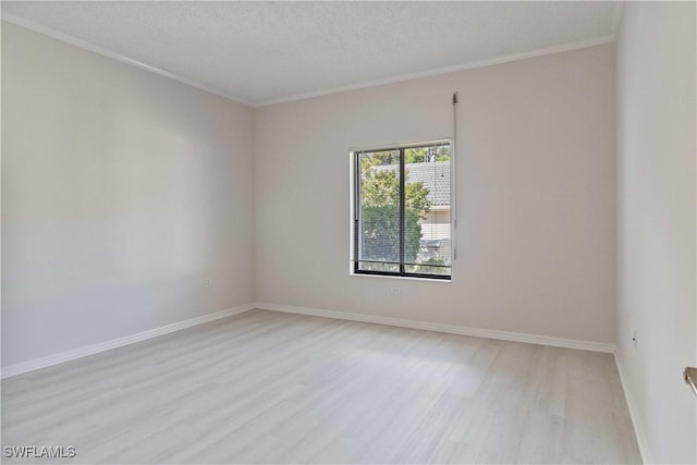 unfurnished room featuring light hardwood / wood-style floors, a textured ceiling, and ornamental molding