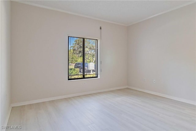 unfurnished room featuring light hardwood / wood-style flooring and ornamental molding