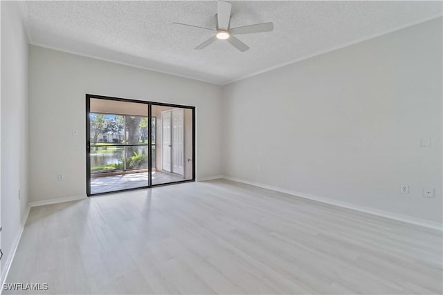 empty room featuring ceiling fan, a textured ceiling, and light wood-type flooring