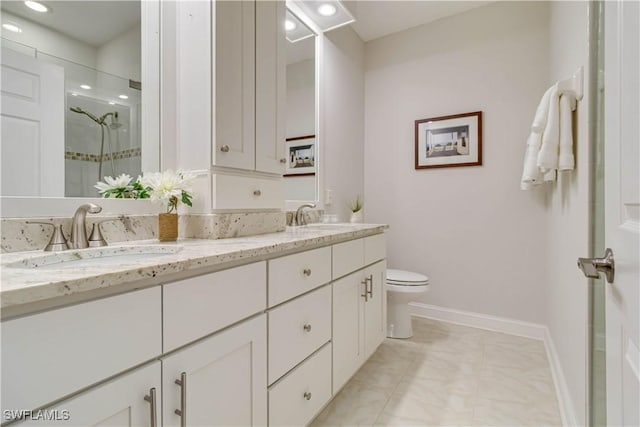 bathroom featuring a shower stall, baseboards, double vanity, toilet, and recessed lighting