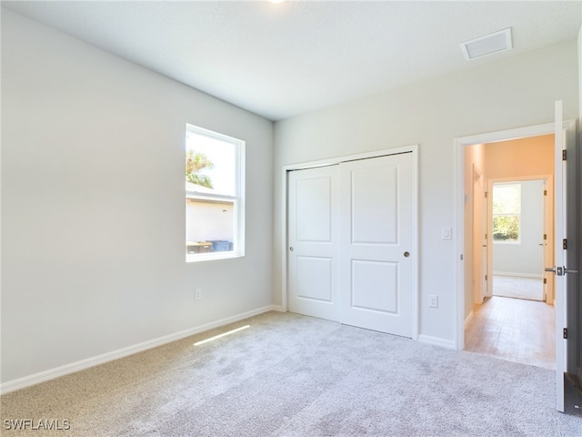 unfurnished bedroom featuring carpet flooring and a closet