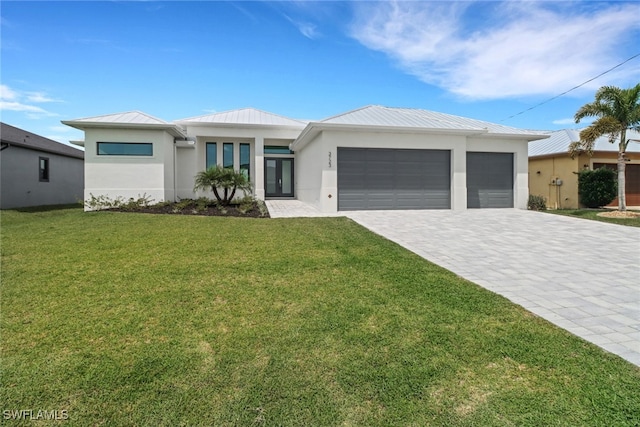 view of front of house featuring a front yard and a garage