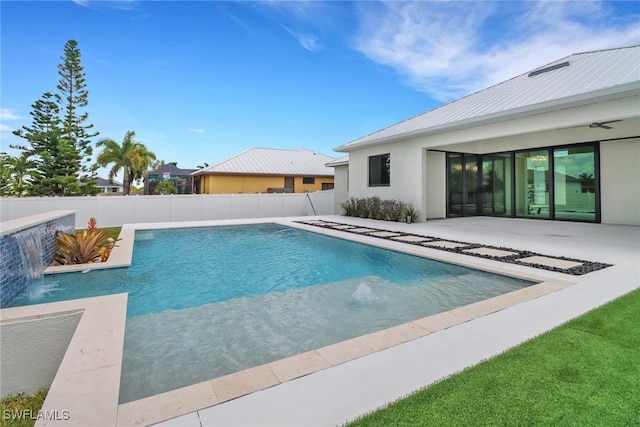 view of swimming pool featuring pool water feature and a patio area