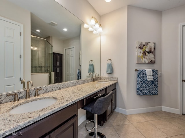 bathroom with vanity, walk in shower, and tile patterned flooring